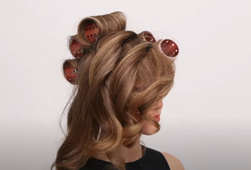 Women with long hair use ceramic curling irons to create shiny curls